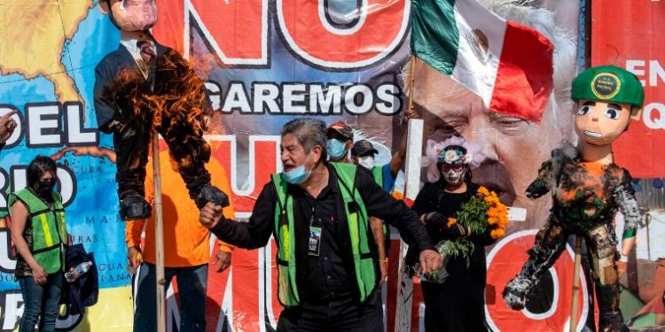 MIGRANTES QUEMAN FIGURA DE TRUMP PARA DENUNCIAR LOS ABUSOS EN TIJUANA